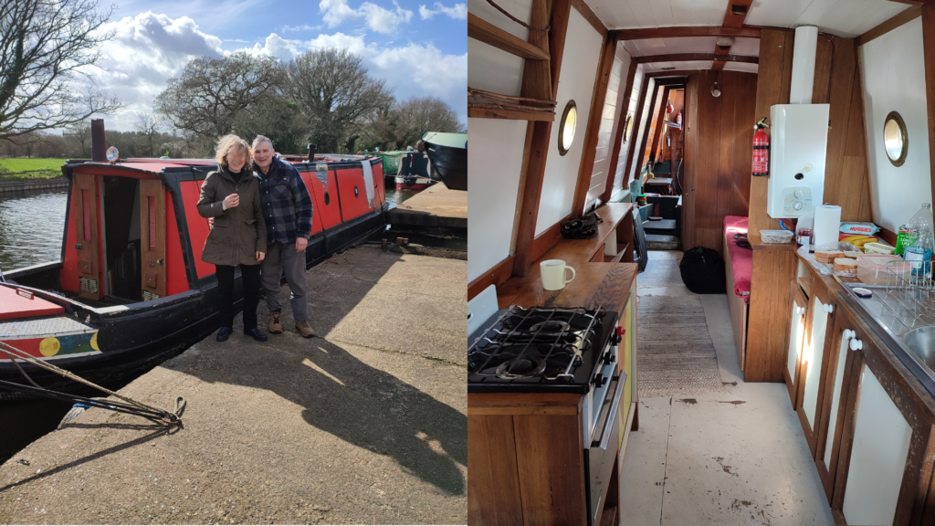 A woman and a man stand together beside a red narrowboat on a sunny, breezy day, smiling as they prepare to take ownership of their new boat. This moment marks the beginning of what would become Simple Life Explorers. The narrowboat is moored along a canal, with trees, grass, and a bright sky in the background.